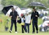 Canadians Taylor Pendrith (left), Nick Taylor (right) and Mackenzie Hughes (back) walk up the 17th fairway as rain falls in the first round of the Canadian Open golf tournament in Alton, Ont., Thursday, June 5, 2025. THE CANADIAN PRESS/Frank Gunn