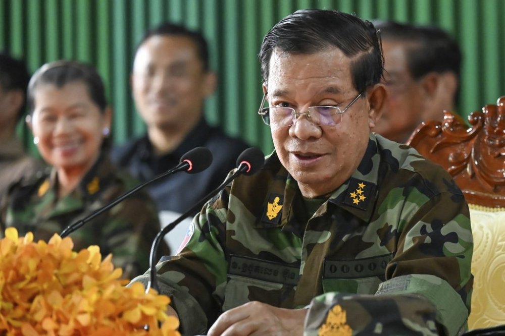 In this photo released by Agence Kampuchea Press (AKP), Cambodian Senate President Hun Sen, right, delivers a speech during his visit to Oddar Meanchey province, near Cambodia-Thailand border of northern province of Cambodia, Thursday, June 26, 2025. (AKP via AP)