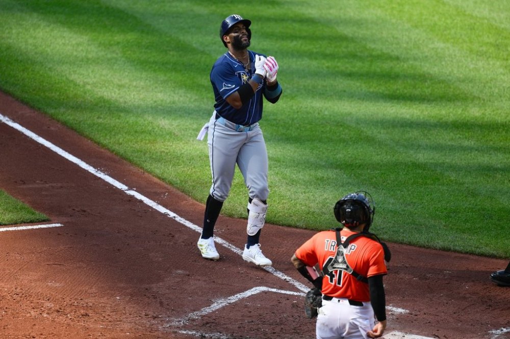 Tampa Bay Rays' Yandy Diaz, left, celebrates his three-run home run during the fourth inning of a baseball game as Baltimore Orioles catcher Chadwick Tromp looks on at right, Saturday, June 28, 2025, in Baltimore. (AP Photo/Nick Wass)