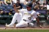 Pittsburgh Pirates' Bryan Reynolds scores on a sacrifice fly hit by Adam Frazier during the eighth inning of a baseball game against the Miami Marlins, Wednesday, June 11, 2025, in Pittsburgh. (AP Photo/Matt Freed)