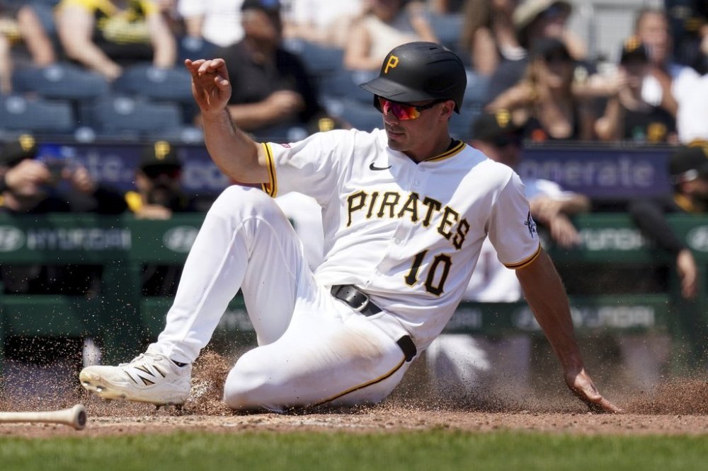 Pittsburgh Pirates' Bryan Reynolds scores on a sacrifice fly hit by Adam Frazier during the eighth inning of a baseball game against the Miami Marlins, Wednesday, June 11, 2025, in Pittsburgh. (AP Photo/Matt Freed)