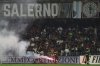 Firefighters tend to a flare thrown onto the pitch during a playoff between Sampdoria and Salernitana to stay in Serie B, which caused the suspension of the match, at the at the Arechi Stadium in Salerno, southern Italy, Sunday, July 22, 2025. (Alessandro Garofalo/LaPresse via AP)