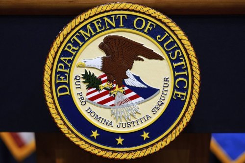 FILE - The U.S. Department of Justice logo is seen on a podium before a press conference with Attorney General Pam Bondi, Tuesday, May 6, 2025, at the Justice Department in Washington. (AP Photo/Julia Demaree Nikhinson, file)