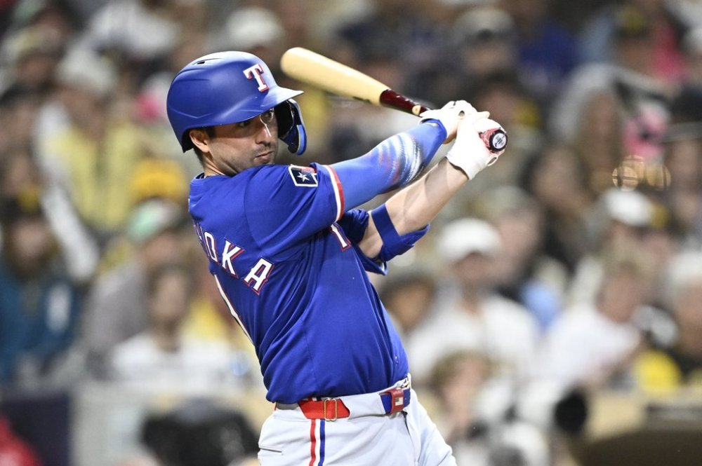 Texas Rangers' Kyle Higashioka (11) hits an RBI single during the eighth inning of a baseball game against the San Diego Padres Saturday, July 5, 2025. (AP Photo/Denis Poroy)