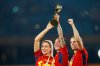 FILE - Spain's Alexia Putellas, Jennifer Hermoso and Irene Paredes, from left, celebrate with the trophy at the end of the Women's World Cup soccer final between Spain and England at Stadium Australia in Sydney, Australia, Aug. 20, 2023. (AP Photo/Abbie Parr, File)