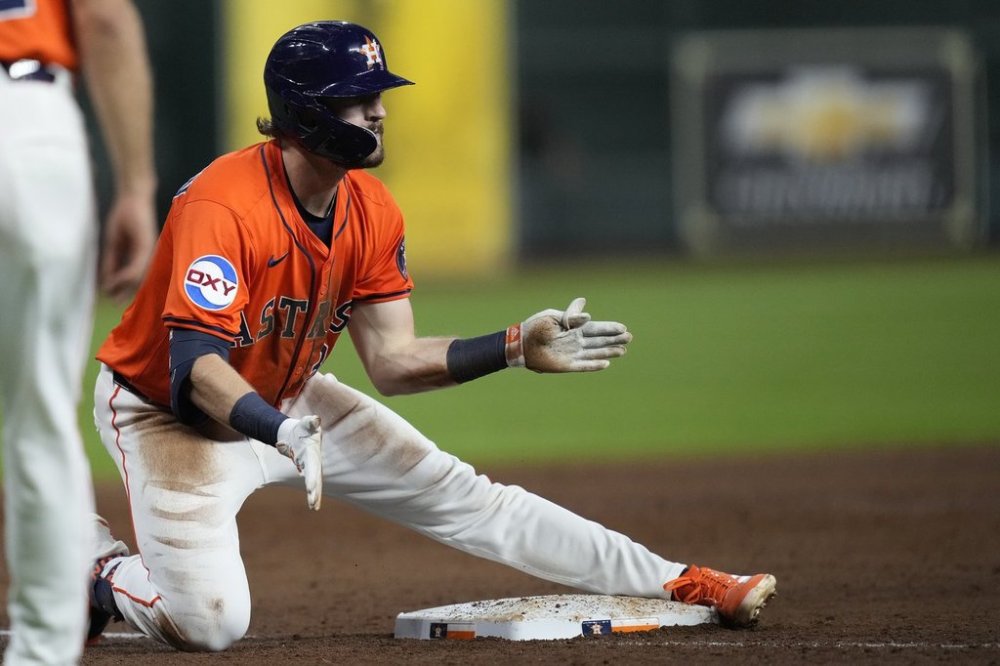 Houston Astros' Jacob Melton celebrates after hitting a two-run triple during the third inning of a baseball game against the Minnesota Twins, Friday, June 13, 2025, in Houston. (AP Photo/Kevin M. Cox)