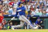 New York Mets' Juan Soto follows through on a solo home run in the third inning of a baseball game against the Philadelphia Phillies, Saturday, June 21, 2025, in Philadelphia. (AP Photo/Laurence Kesterson)