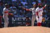 Washington Nationals' CJ Abrams, second from right, gestures after hitting an RBI triple during the 11th inning of a baseball game against the Los Angeles Angelsm Sunday, June 29, 2025, in Anaheim, Calif. (AP Photo/William Liang)