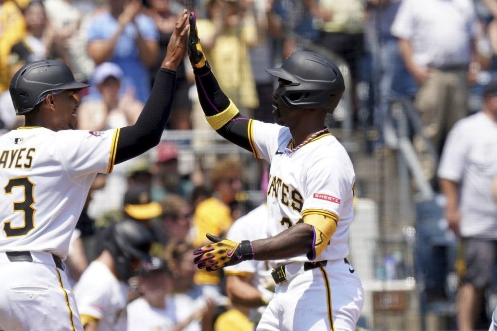 Pittsburgh Pirates' Andrew McCutchen, right, celebrates with Ke'Bryan Hayes, left, after hitting a three-run home run during the fifth inning of a baseball game against the Miami Marlins Wednesday, June 11, 2025, in Pittsburgh. (AP Photo/Matt Freed)