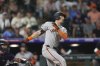 San Francisco Giants' Mike Yastrzemski singles to drive in the go-ahead run off Colorado Rockies relief pitcher Victor Vodnik in the ninth inning of a baseball game Tuesday, June 10, 2025, in Denver. (AP Photo/David Zalubowski)