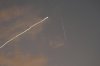 A smoke trail from the Israeli Iron Dome air defense system streaks across the sky as it intercepts missiles launched during an Iranian attack, as seen from Haifa, Israel, early Tuesday, June 24, 2025. (AP Photo/Baz Ratner)