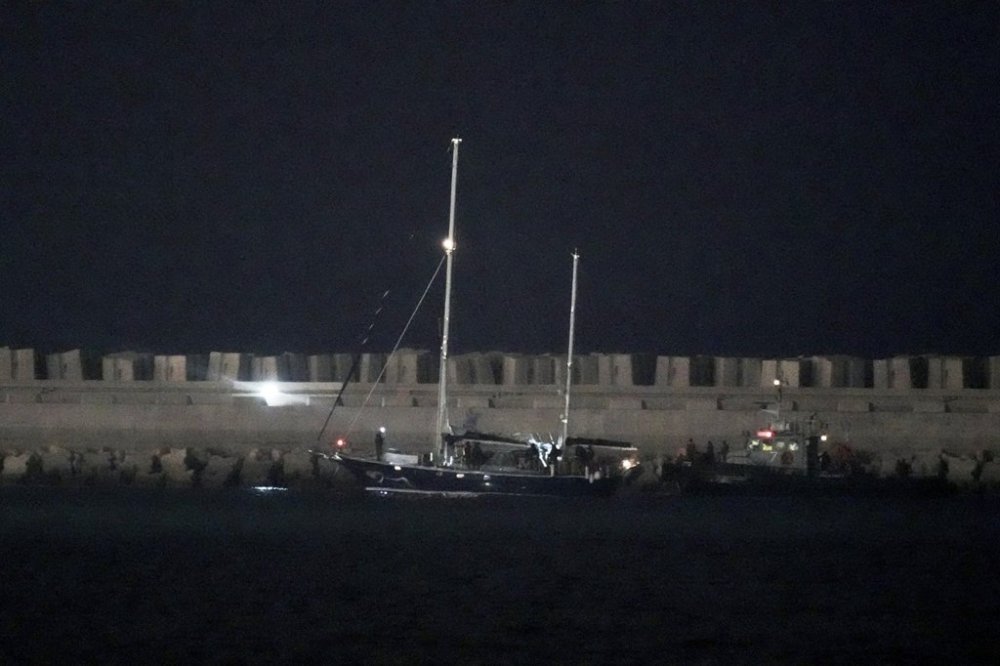 The Gaza-bound aid boat, Madleen, under escort of Israeli naval forces enters to Ashdod Port in southern Israel after being seized by Israeli forces, Monday, June 9, 2025. (AP Photo/Leo Correa)