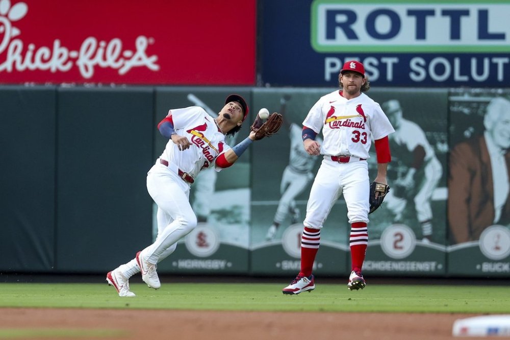 St. Louis Cardinals' Masyn Winn, left, catches a fly ball for an out against Toronto Blue Jays' Addison Barger while Brendan Donovan watches during the first inning of a baseball game Tuesday, June 10, 2025, in St. Louis. (AP Photo/Scott Kane)