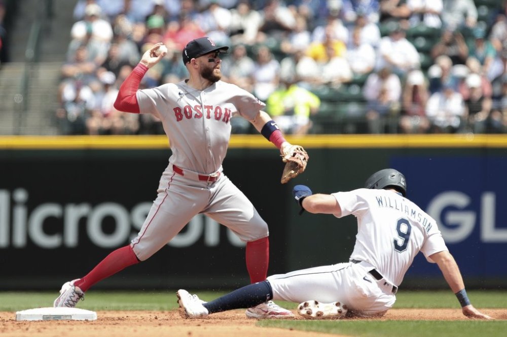 Boston Red Sox shortstop Trevor Story, left, tags to get Seattle Mariners' Ben Williamson (9) out at second during the second inning of a baseball game, Wednesday, June 18, 2025, in Seattle. (AP Photo/Jason Redmond)