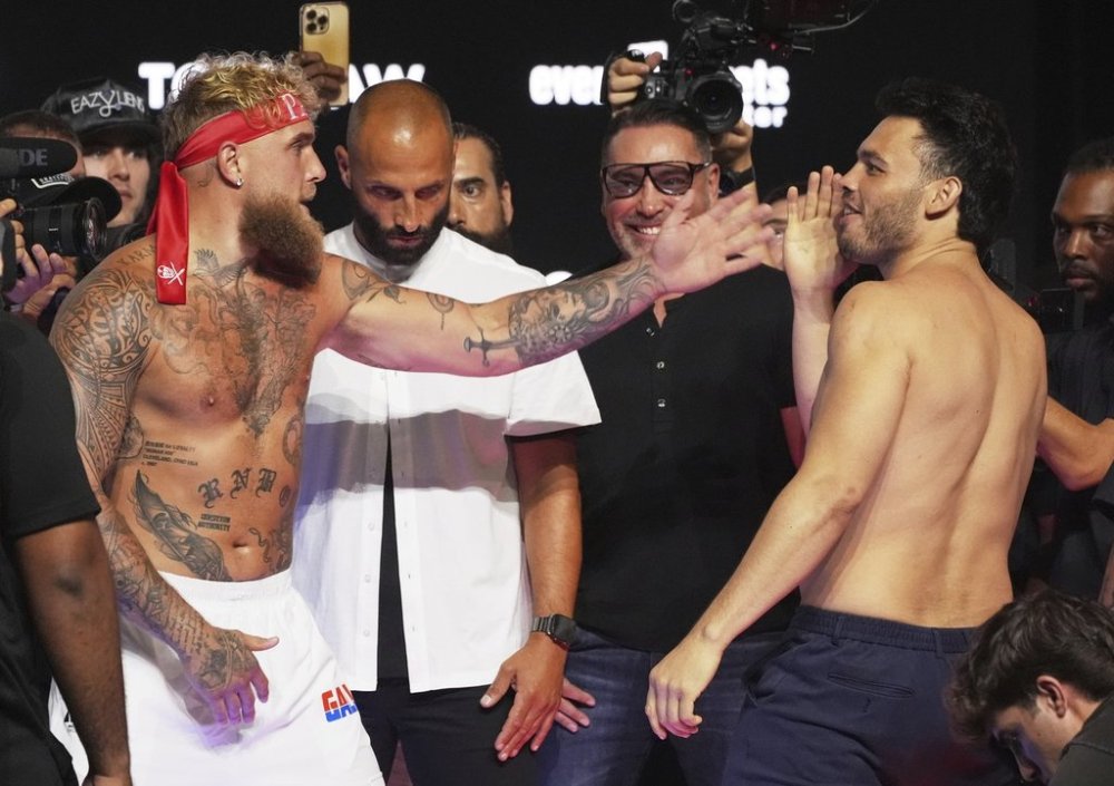 Jake Paul, left, and Julio Cesar Chavez Jr., right, taunt each other following a weigh-in ahead of their cruiserweight boxing match, Friday, June 27, 2025, in Anaheim, Calif. (AP Photo/Chris Pizzello)