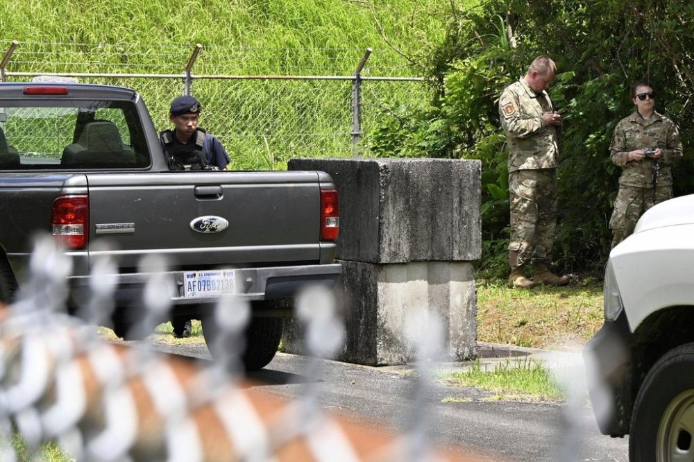 U.S. military persons gather near the site of an explosion at a storage site for unexploded ordnances at a U.S. military base in the town of Yomitanson, Okinawa prefecture, southern Japan Monday, June 9, 2025. (Kyodo News via AP)