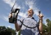 Victor Surerus poses for a photo at his farm in Roseneath, Ontario, on Wednesday, June 24, 2015 with the first cellphone in Canada. THE CANADIAN PRESS/Fred Thornhill