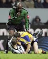 FILE - Referee Uriah Rennie looks on as Newcastle United's Lee Bowyer, bottom, has a tussle with Southampton's Neil McCann during their English Premier League soccer match at St James' Park, Newcastle, England, Saturday Jan. 15, 2005. (AP Photo/Scott Heppell, File)