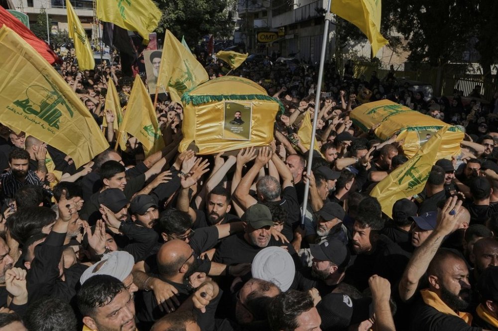 Mourners carry the coffins of Abu Ali Khalil, the bodyguard and head of security for late Hezbollah leader Sayyed Hassan Nasrallah, and his son Mahdi, who were killed in an Israeli airstrike in Iran on June 21, during their funeral procession in Dahiyeh, a southern suburb of Beirut, Lebanon, Thursday, July 3, 2025. (AP Photo/Bilal Hussein)