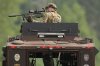 A law enforcement officer trains his rifle towards a house as the officers search for shooting suspect, Vance Boelter, Sunday, June 15, 2025, in Belle Plaine, Minn. (AP Photo/George Walker IV)