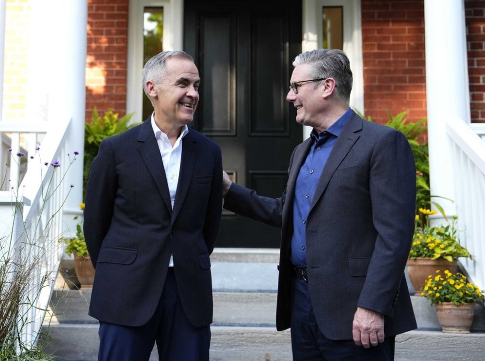 Prime Minister Mark Carney greets Prime Minister of the United Kingdom Keir Starmer, outside his residence at Rideau Cottage in Ottawa, for a visit before the G7 Summit in Kananaskis, Alta., on Saturday, June 14, 2025. THE CANADIAN PRESS/Justin Tang