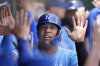 Kansas City Royals' Salvador Perez celebrates in the dugout after scoring on a two-run double hit by Kansas City Royals' John Rave during the second inning of a baseball game against the New York Mets, Sunday, July 13, 2025, in Kansas City, Mo. (AP Photo/Charlie Riedel)