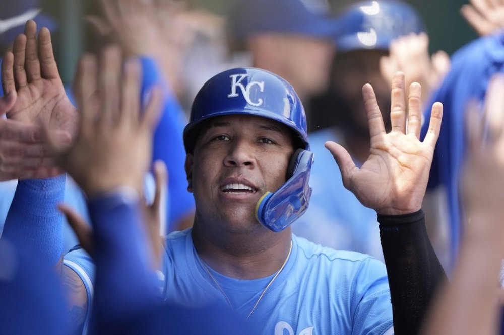 Kansas City Royals' Salvador Perez celebrates in the dugout after scoring on a two-run double hit by Kansas City Royals' John Rave during the second inning of a baseball game against the New York Mets, Sunday, July 13, 2025, in Kansas City, Mo. (AP Photo/Charlie Riedel)