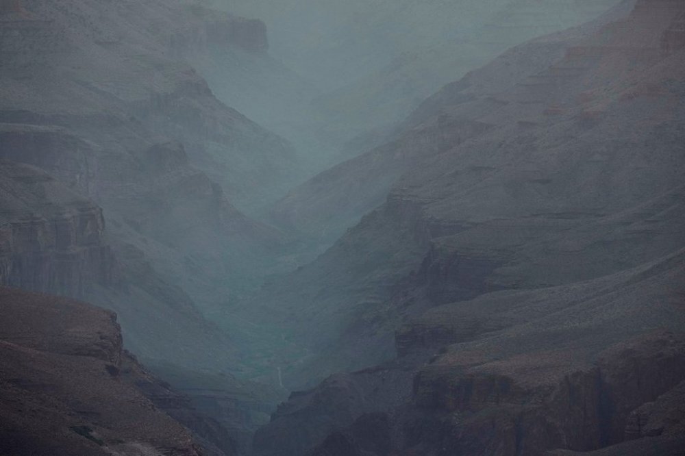 Smoke from the Dragon Bravo Fire moves down the Grand Canyon from the North Rim Tuesday, July 15, 2025, in Grand Canyon National Park, Ariz. (AP Photo/Ross D. Franklin)
