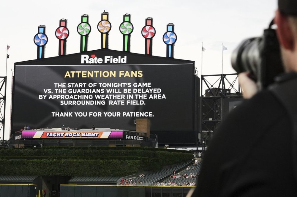 The Jumbotron displays information about a rain delay before a baseball game between the Cleveland Guardians and the Chicago White Sox in Chicago, Thursday, July 10, 2025. (AP Photo/Nam Y. Huh)