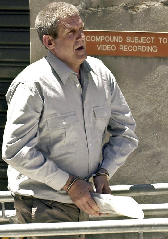 FILE - Bradley John Murdoch is led through the compound at the Adelaide Magistrates court, Adelaide, Australia, Nov. 13, 2003. (AP Photo/David Mariuz, File)
