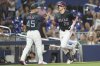 Miami Marlins' Kyle Stowers (28) passes third base coach Blake Lalli (45) after hitting a solo home run during the third inning of a baseball game against the Milwaukee Brewers, Saturday, July 5, 2025, in Miami. (AP Photo/Lynne Sladky)