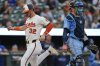 Baltimore Orioles' Ryan O'Hearn (32) scores past Toronto Blue Jays catcher Tyler Heineman, right, on a groundout hit by Ramon Urias during the fourth inning in the second baseball game of a doubleheader, Tuesday, July 29, 2025, in Baltimore. (AP Photo/Stephanie Scarbrough)