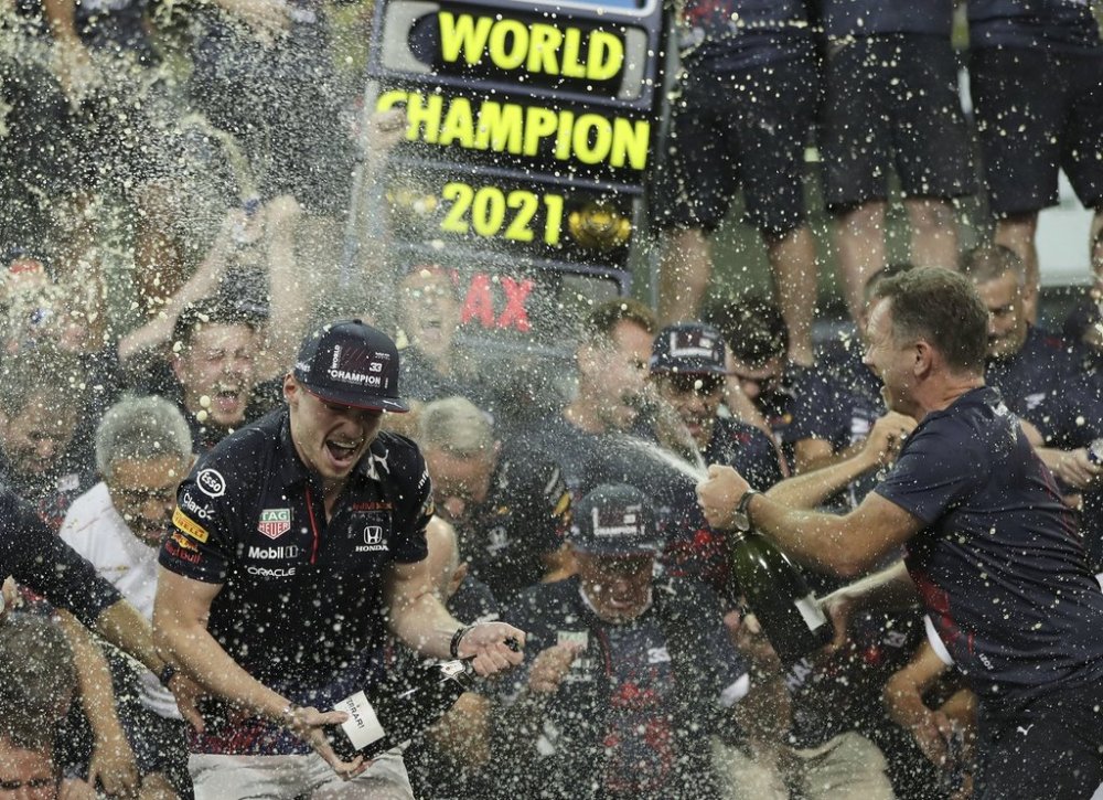 FILE - Red Bull driver Max Verstappen of the Netherlands, left, celebrates with Red Bull team chief Christian Horner, right, and his team in the pit lane after becoming F1 drivers world champion after winning the Formula One Abu Dhabi Grand Prix in Abu Dhabi, United Arab Emirates, Sunday, Dec. 12. 2021. (AP Photo/Kamran Jebreili, File)