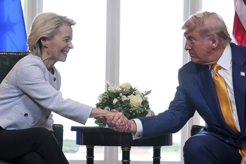 President Donald Trump and European Commission President Ursula von der Leyen shake hands after reaching a trade deal at the Trump Turnberry golf course in Turnberry, Scotland Sunday, July 27, 2025. (AP Photo/Jacquelyn Martin)