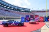 In this image provided by Bristol Moto Speedway, an Atlanta Braves, left, and Cincinnati Reds themed race cars are display at Bristol Motor Speedway, Thursday, July 31, 2025, in Bristol, Tenn., as preparations continue for the MLB Speedway Classic baseball game between the Reds and Braves on Aug. 2. (Earl Neikirk/Bristol Motor Speedway via AP