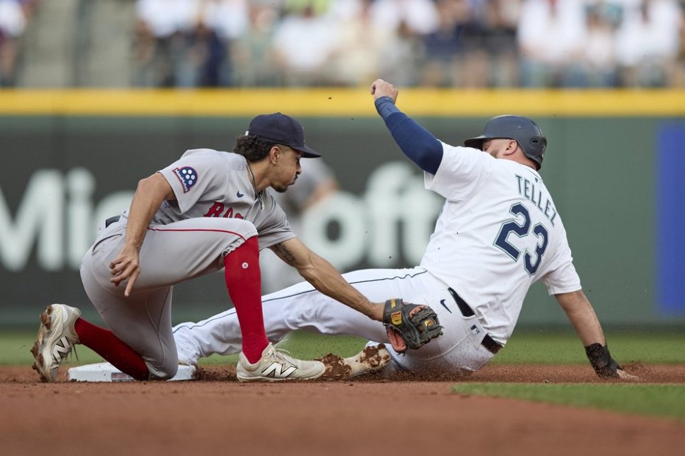 Seattle Mariners' Rowdy Tellez steals second as Boston Red Sox second baseman David Hamilton reaches to tag during the second inning of a baseball game, Tuesday, June 17, 2025, in Seattle. (AP Photo/John Froschauer)