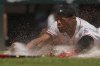 Cincinnati Reds' Will Benson slides safely into home to score on a single hit by Matt McLain during the sixth inning of a baseball game against the Atlanta Braves, Friday, Aug. 1, 2025, in Cincinnati. (AP Photo/Carolyn Kaster)