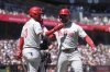 Philadelphia Phillies' Kyle Schwarber, right, is congratulated by Bryce Harper after hitting a three-run home run that also scored J.T. Realmuto and Trea Turner during the eighth inning of a baseball game against the San Francisco Giants in San Francisco, Wednesday, July 9, 2025. (AP Photo/Jeff Chiu)