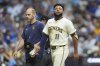Milwaukee Brewers' Jackson Chourio (11) looks on as he walks to the dugout after suffering an injury during the fifth inning of a baseball game against the Chicago Cubs, Tuesday, July 29, 2025, in Milwaukee. (AP Photo/Aaron Gash)