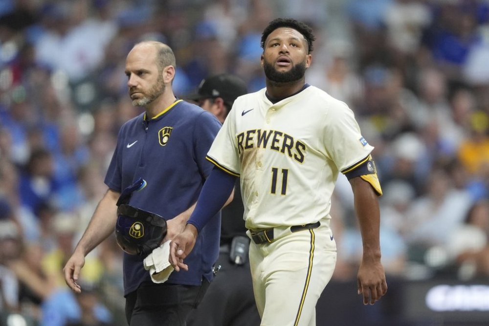 Milwaukee Brewers' Jackson Chourio (11) looks on as he walks to the dugout after suffering an injury during the fifth inning of a baseball game against the Chicago Cubs, Tuesday, July 29, 2025, in Milwaukee. (AP Photo/Aaron Gash)
