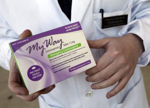 In this May 2, 2013 photo, pharmacist Simon Gorelikov holds a generic emergency contraceptive, also called the morning-after pill, at the Health First Pharmacy in Boston. (AP Photo/Elise Amendola, File)
