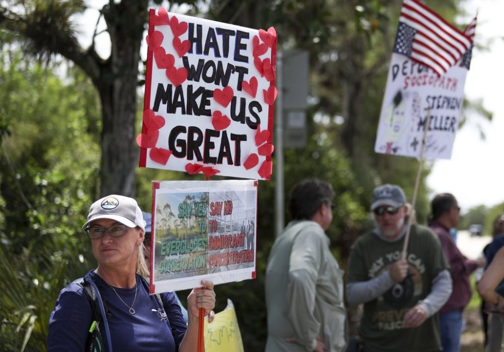 A protester stands outside the migrant detention facility dubbed