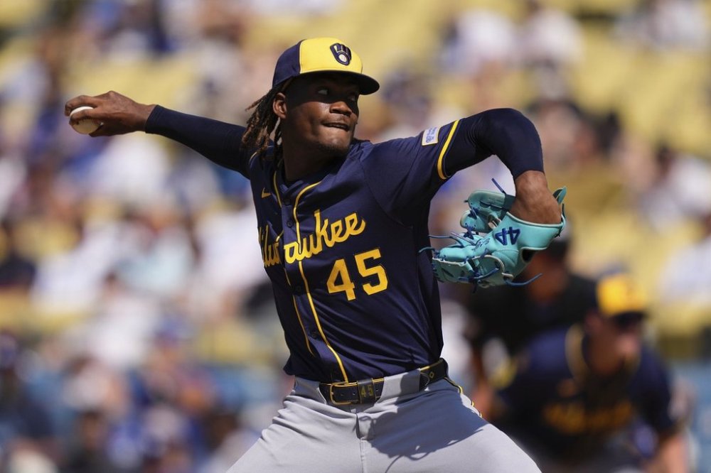Milwaukee Brewers relief pitcher Abner Uribe throws to the plate during the ninth inning of a baseball game against the Los Angeles Dodgers, Sunday, July 20, 2025, in Los Angeles. (AP Photo/Mark J. Terrill)