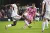 Toronto FC defender Nicksoen Gomis, left, beats Inter Miami midfielder Sergio Busquets to a ball, during the first half of an MLS soccer match, Sunday, April 6, 2025, in Fort Lauderdale, Fla. (AP Photo/Rebecca Blackwell)