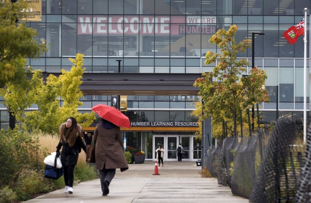 People walk on the campus of Humber College, in Toronto on Monday, Oct. 16, 2017. THE CANADIAN PRESS/Cole Burston