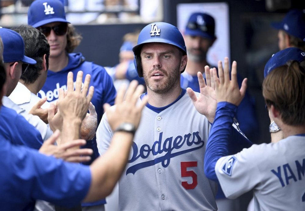 Los Angeles Dodgers' Freddie Freeman (5) celebrates after scoring on a single by Andy Pages during the sixth inning of a baseball game against the Tampa Bay Rays, Sunday, Aug. 3, 2025, in Tampa, Fla. (AP Photo/Jason Behnken)