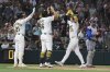 Athletics' Brent Rooker, right, celebrates hitting a two-run home run with Nick Kurtz, centre, and Tyler Soderstrom, left, at home plate during the fifth inning of a baseball game Saturday, July 12, 2025, in West Sacramento, Calif. (AP Photo/Sara Nevis)