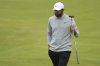 Scottie Scheffler of the United States acknowledges the crowd on the 18th green during the second round of the British Open golf championship at the Royal Portrush Golf Club, Northern Ireland, Friday, July 18, 2025. (AP Photo/Peter Morrison)