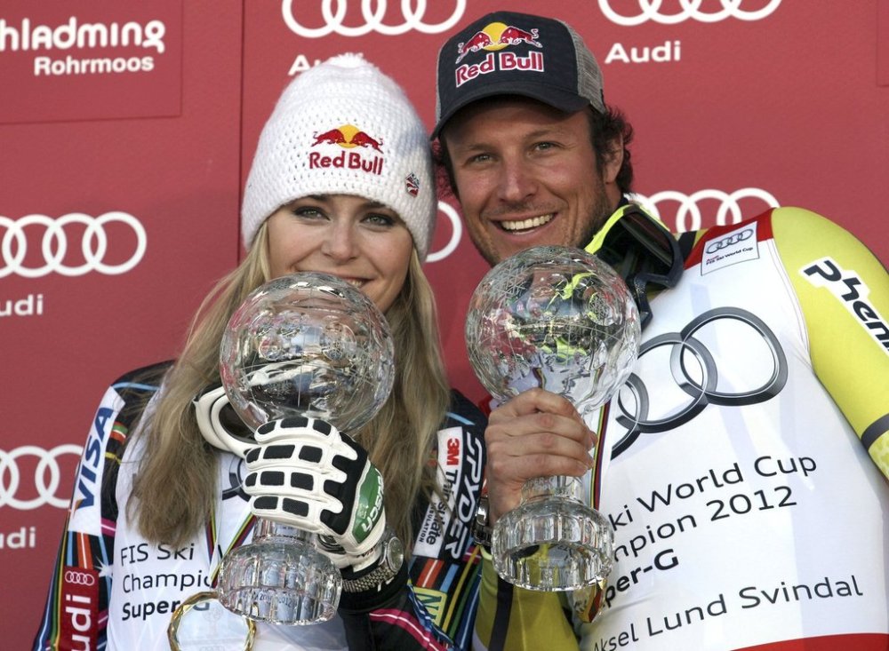 FILE - Lindsey Vonn, of the United States, left, and Norway's Aksel Lund Svindal pose with their trophies of the alpine ski, women's and men's World Cup super-G discipline titles, in Schladming, Austria, Thursday, March 15, 2012. (AP Photo/Alessandro Trovati, File)