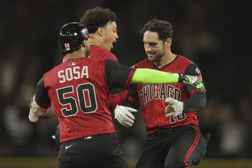 Chicago White Sox's Mike Tauchman, right, celebrates with Miguel Vargas, middle, and Lenyn Sosa (50) after Tauchman's game-winning hit in the 11th inning in the second baseball game of a doubleheader against the Cleveland Guardians, Friday, July 11, 2025, in Chicago. (AP Photo/Melissa Tamez)